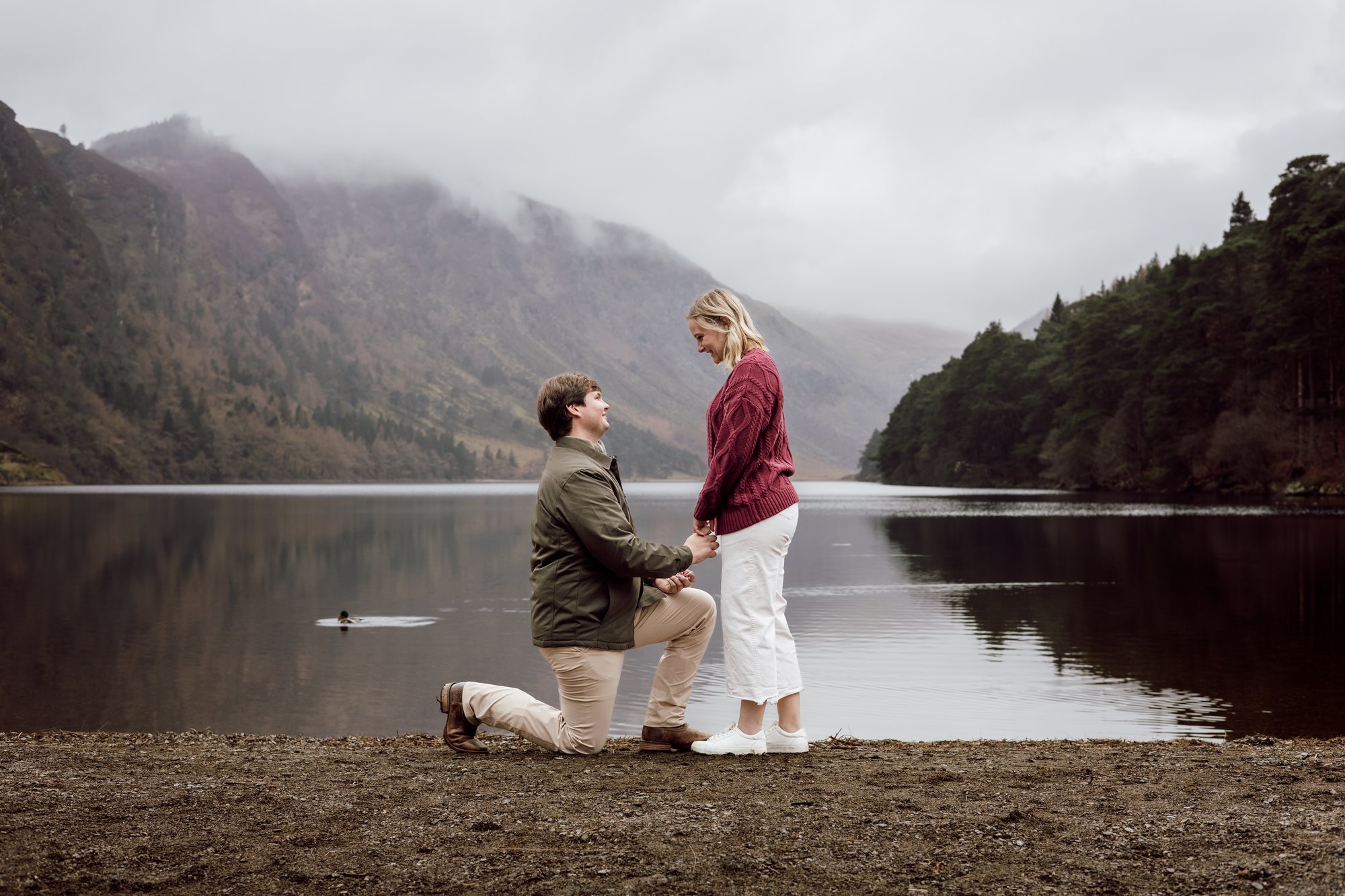 A proposal beside a misty mountain lake