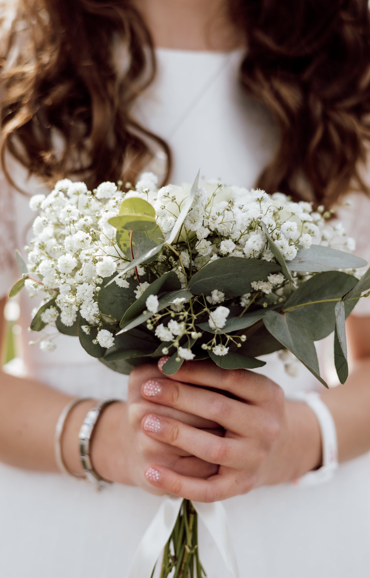 Bride holding a delicate white bouquet