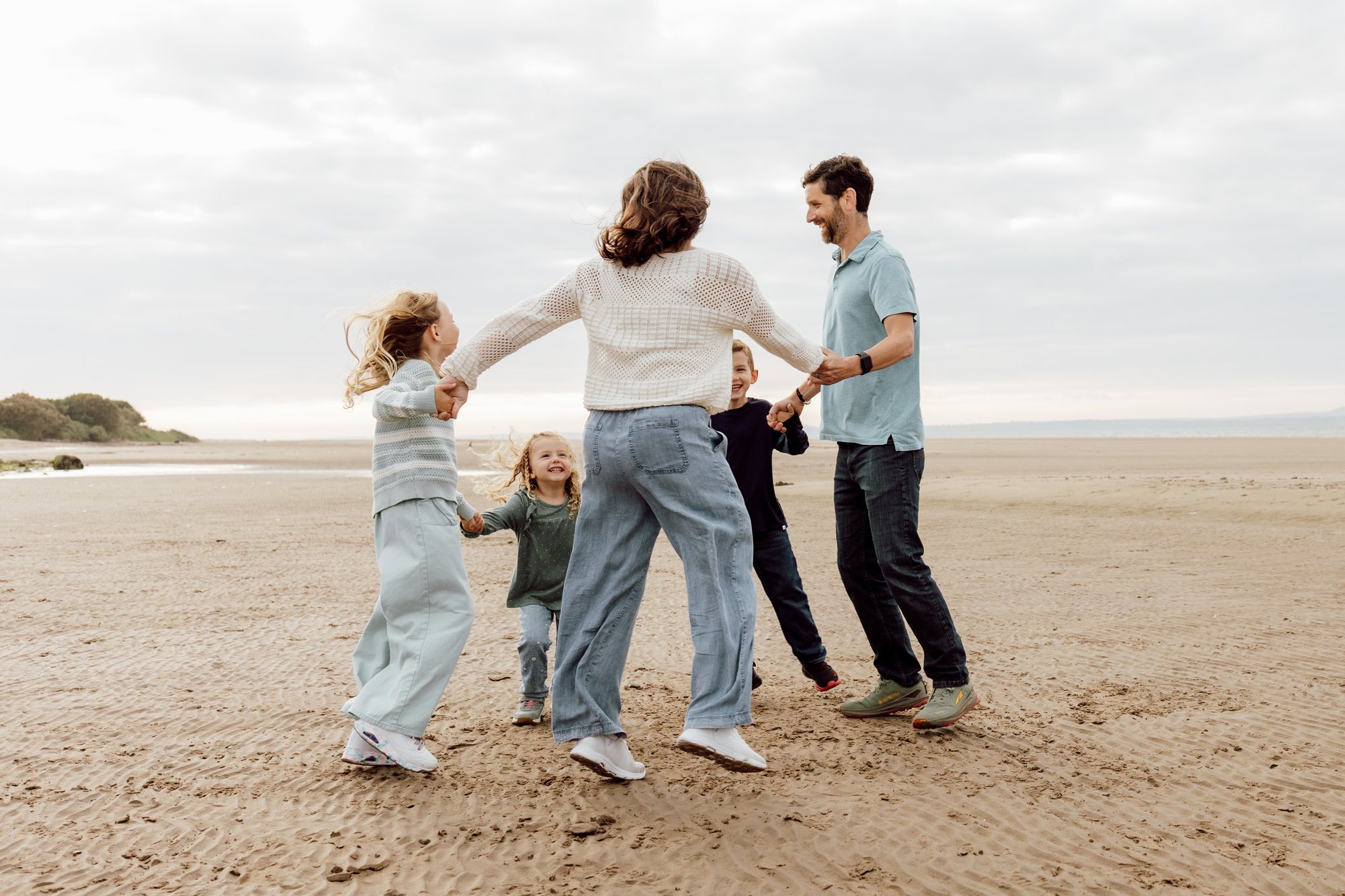 Family playing together on a quiet beach