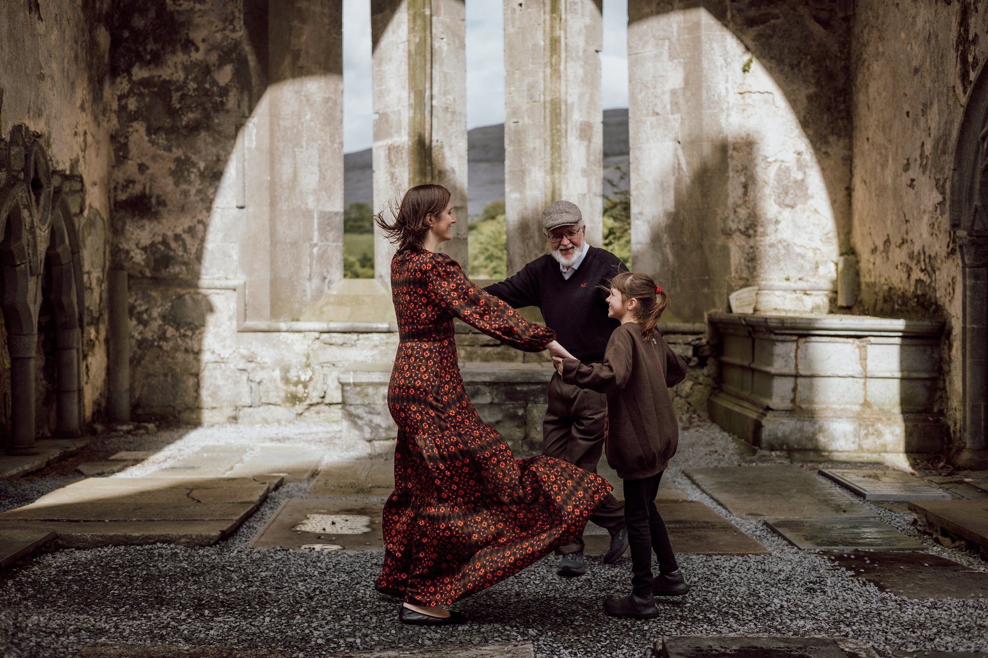 Family sharing a playful moment in an old stone church